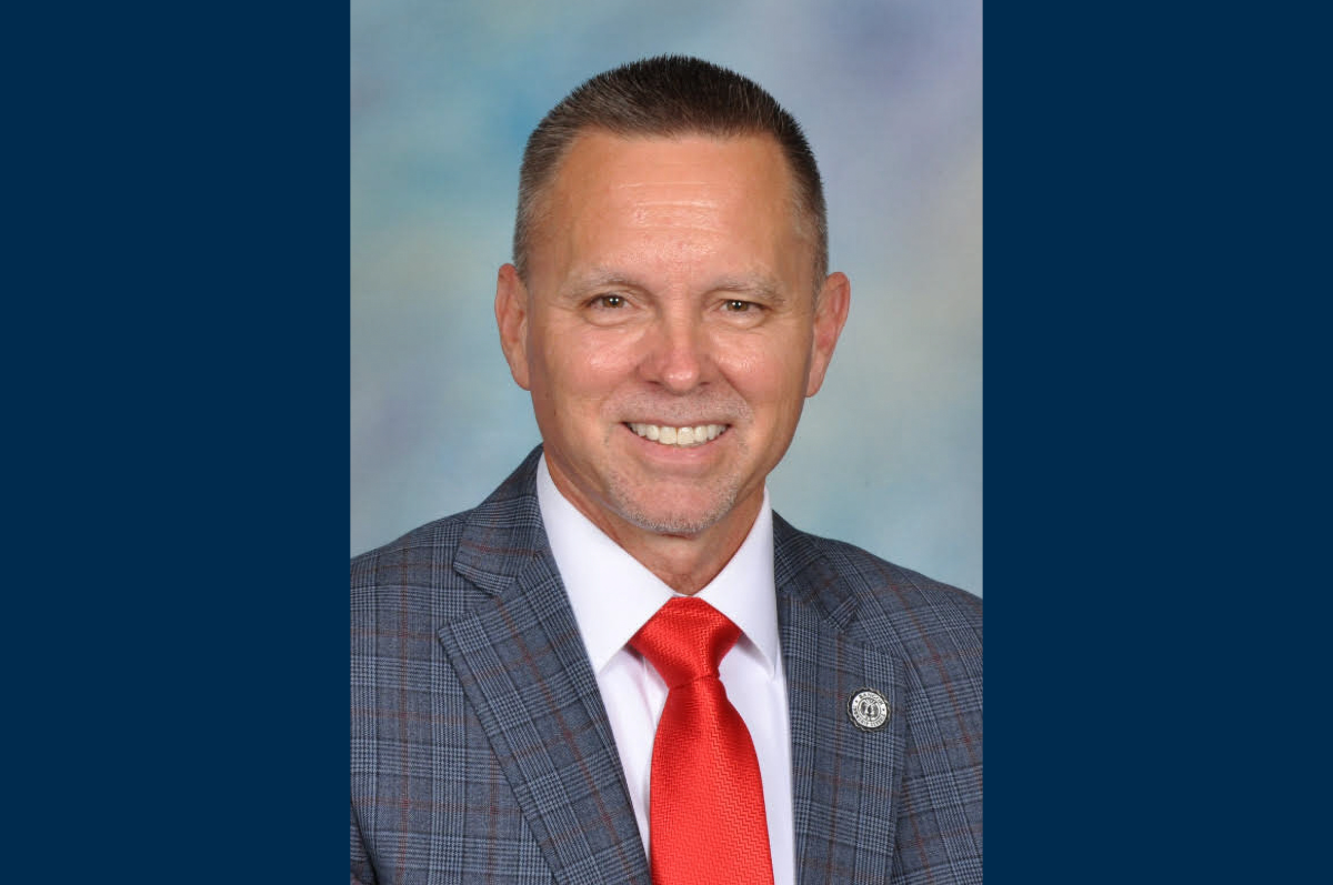 Portrait of man in plaid jacket and red tie
